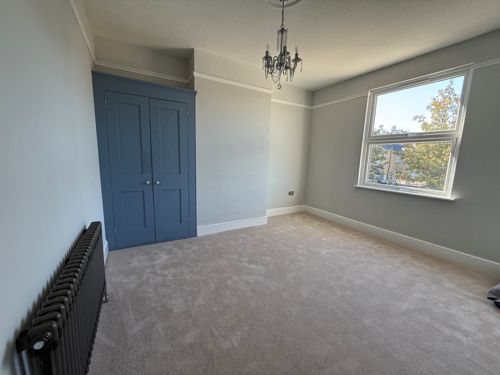 Lot: 132 - THREE-BEDROOM TERRACE HOUSE - Bedroom 2 with window to rear and cupboard
